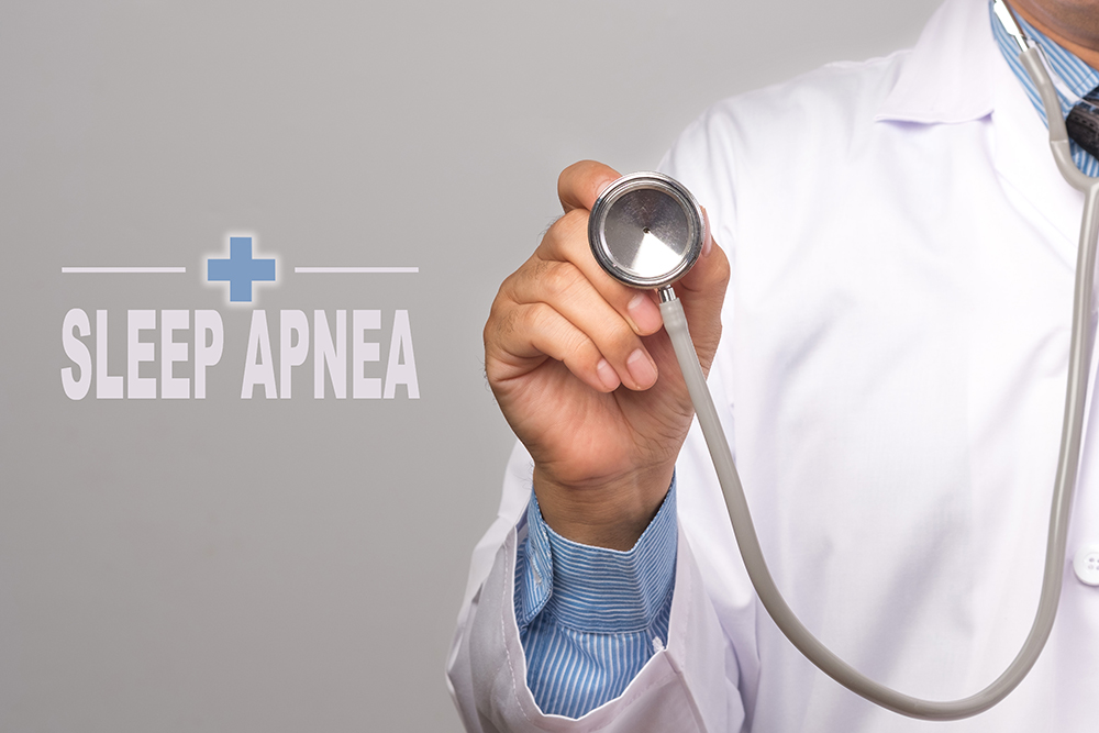 Doctor-holding-a-stethoscope-and-word-SLEEP-APNEA-Immune-System-as-medical-concept