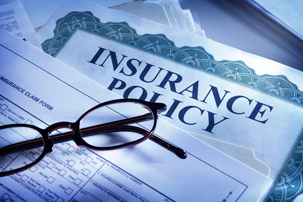 Insurance-claim-form-and-insurance-policy-183427329_5616x3744-1