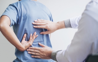 A doctor examining a patient's back